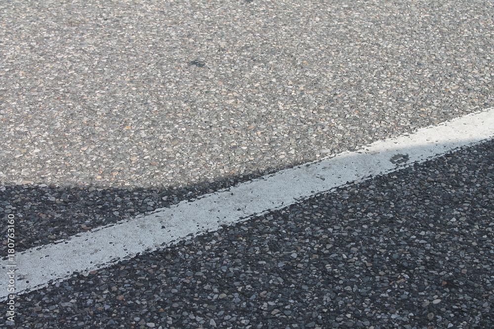 Fototapeta premium Single white dividing traffic line painted on asphalt.