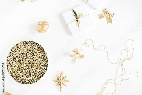 Christmas gifts, golden baubles, stars, garland on white background. Flat lay, top view New Year holiday concept.