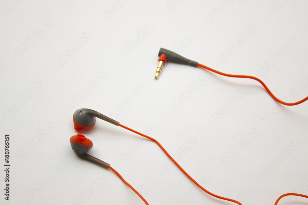 Red earphones on white background. The earphones for using digital music or smart phone. selective focus of earphones. Red earphones on white background. The earphones for using digital music or smart phone. selective focus of earphones.