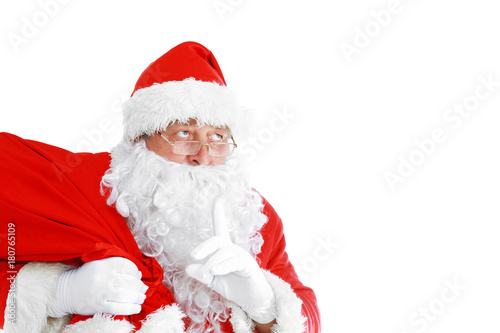 Real Santa Claus carrying big bag full of gifts, isolated on white background