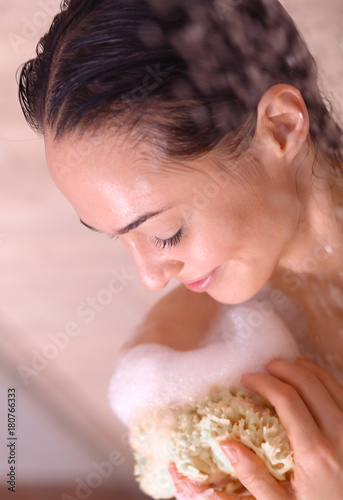 Young beautyful woman under shower in bathroom.