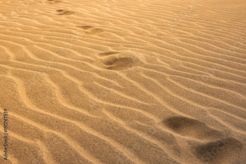 footprints in the sand along the diagon