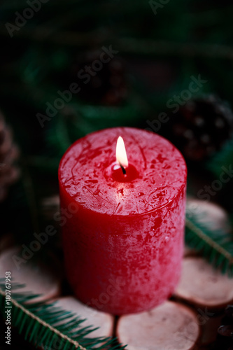 Tableau sur toile Christmas candle with spruce decoration on dark wooden background