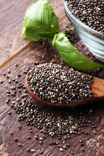 Healthy Chia seeds in a glass bowl wooden background.