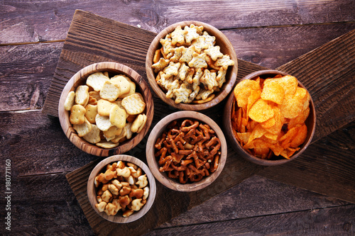 Salty snacks. Pretzels, chips, crackers in wooden bowls.