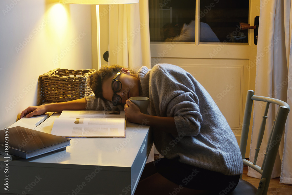 Tired woman student is sleeping on the desk Tired woman student is sleeping on the desk