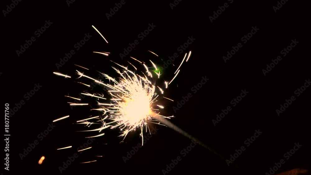 Sparkler up close and bright. Lights sparked and burned in his hands. Festive sparklers close - an attribute of good mood. 
