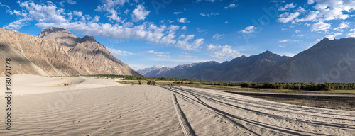 Tire tracks on the sand dunes with blue sky in Nubra Valley, Ladakh, Jammu and Kashmir, Indian