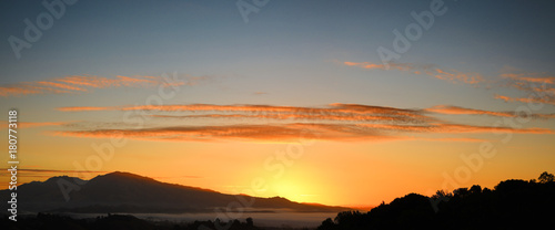 Mount Diablo sunrise panorama over Contra Costa County California showing high clouds and orange sky photo