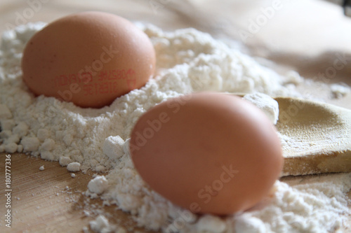 Flour, eggs and wooden spoon