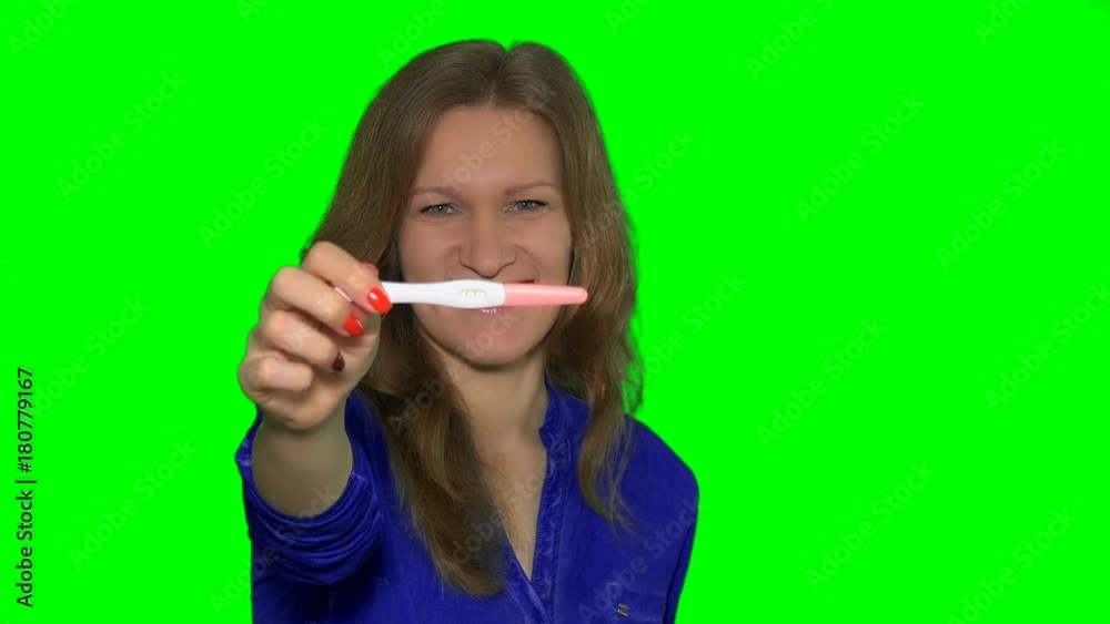 pregnant woman show positive pregnancy test with two stripes to camera and smile pregnant woman show positive pregnancy test with two stripes to camera and smile