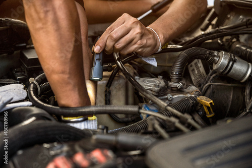 Professional car mechanic working in auto repair service and counseling well