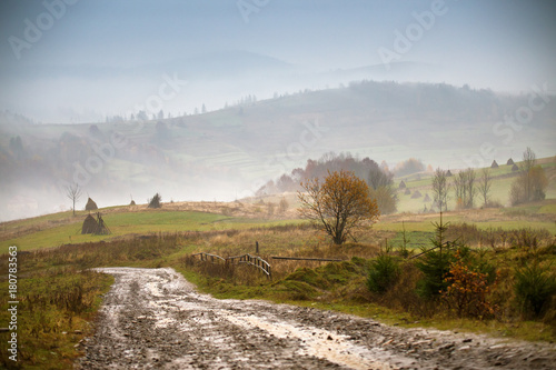 Obraz na płótnie Muddy ground and country road after rain in mountains. w salonie