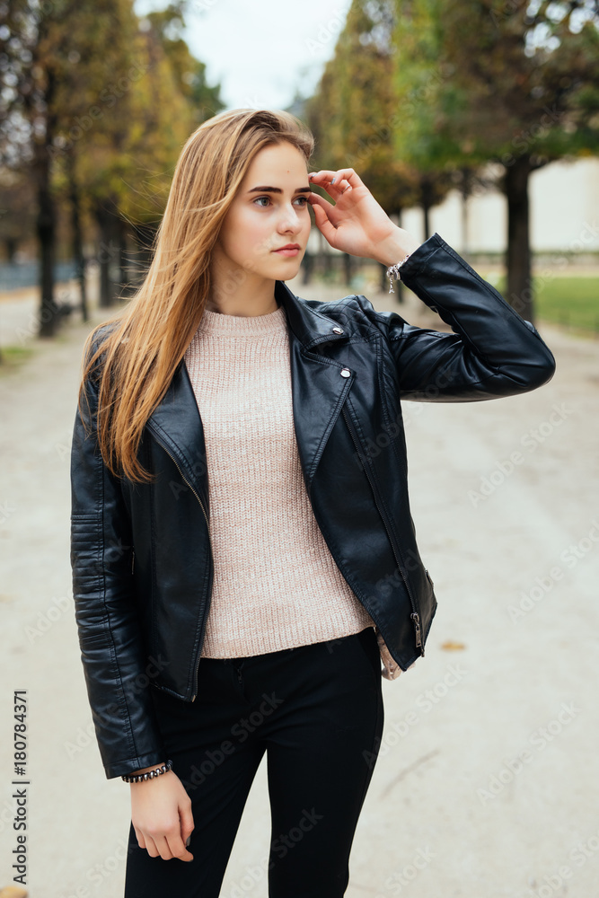Beauty young woman is walking in the city. The girl in the park outdoor. Beauty young woman is walking in the city. The girl in the park outdoor.