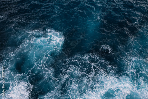 Aerial view to ocean waves. Blue water background © Ivan Kurmyshov