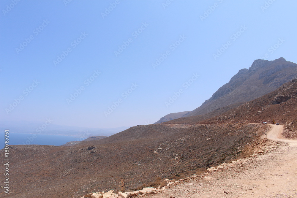 Mediterranean Sea view with the rough terrain of the Balos Lagoon trail in northwestern part of Crete Island in Greece. 