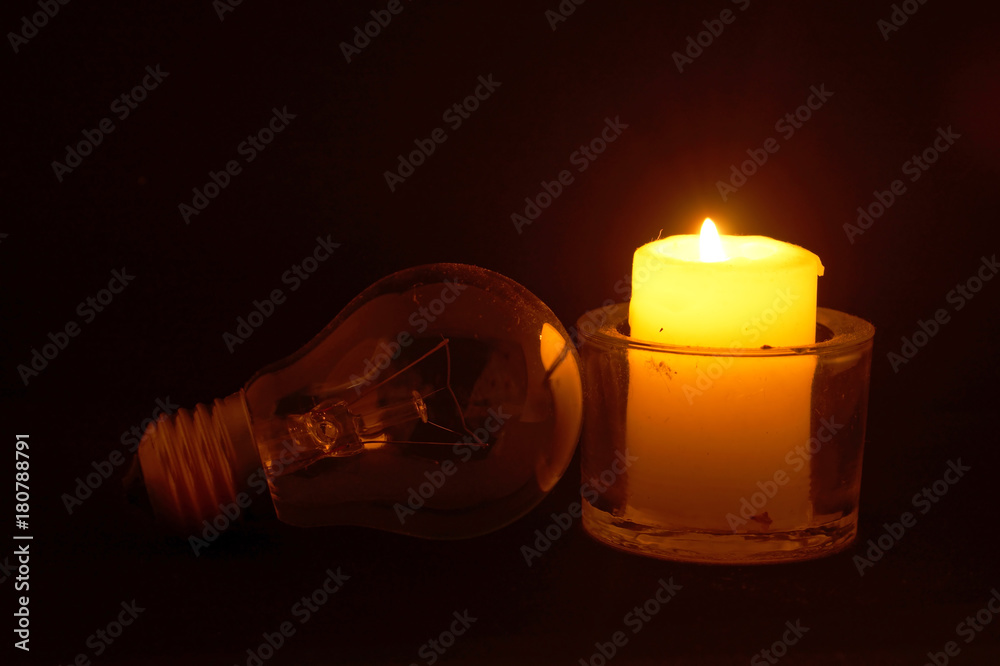 Burning candle and lamp. Power outage.