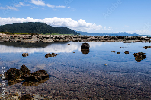 Stunning reflections on beach along the East Cape Road on the north island of New Zealand.