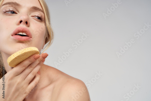beautiful woman holding a spoon at the chin