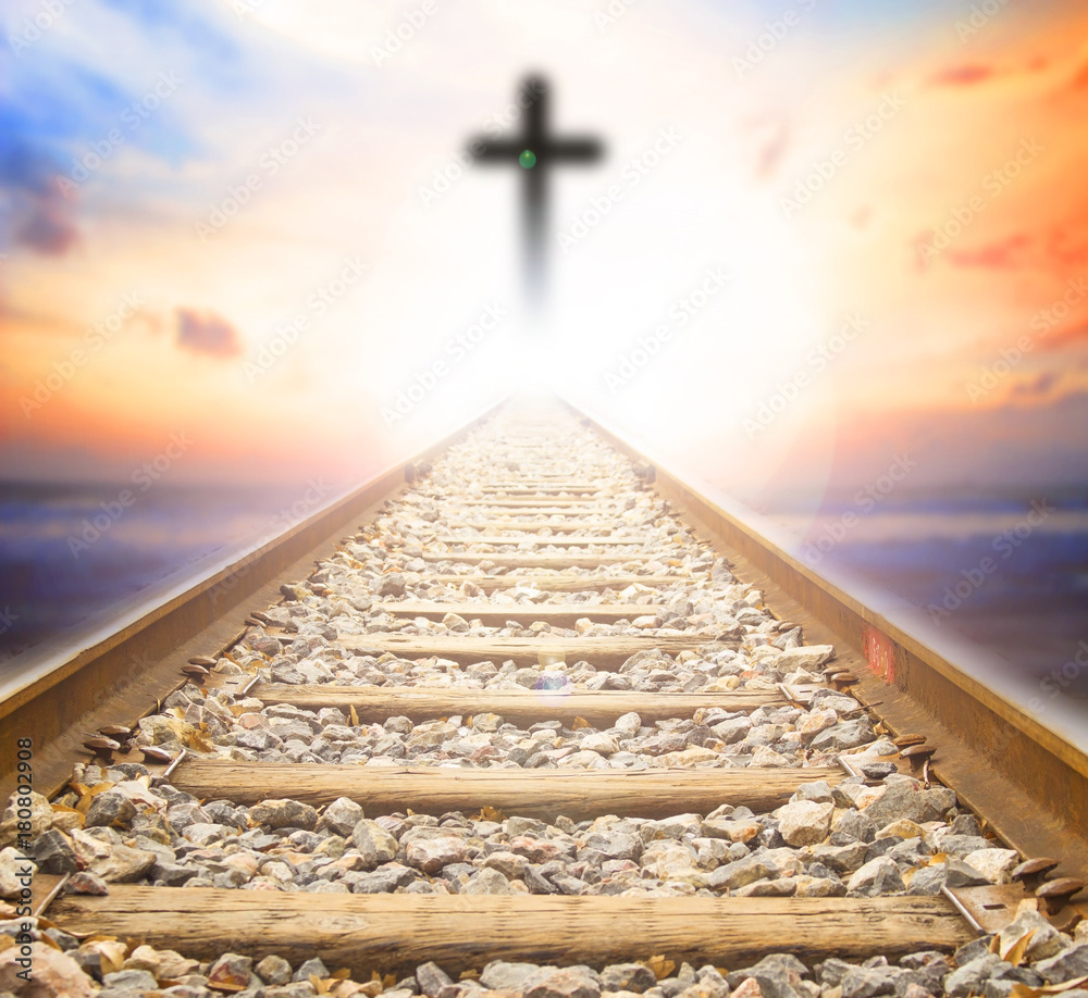 Photography cross on blurry sunset background,