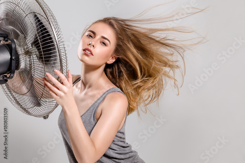 Young woman with cooler fan photo