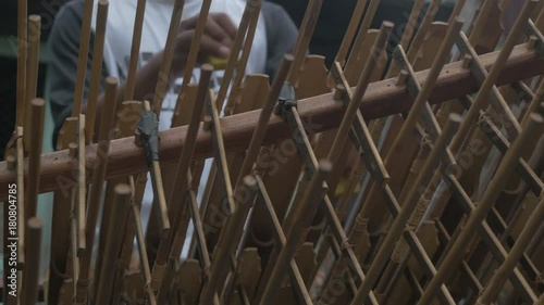 Close up, person pays angklung in Indonesia photo