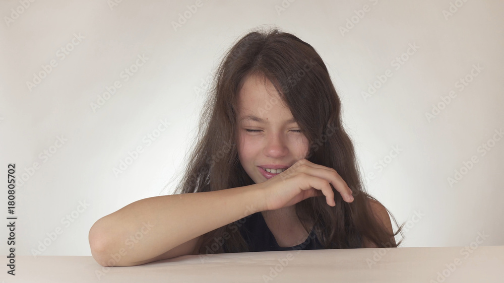 Beautiful sad teenage girl is crying on white background Beautiful sad teenage girl is crying on white background