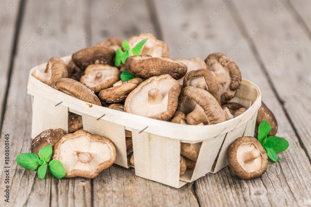 Fototapeta premium Wooden table with Shiitake mushrooms, selective focus
