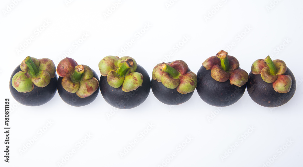 Mangosteen fruit and cross section showing the thick purple skin and