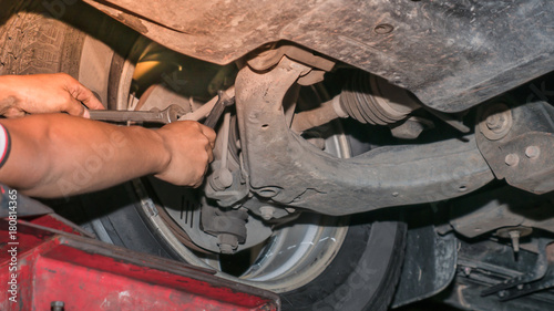 The mechanic using box wrench to manually alignment the wheel balance © Mongkolchon