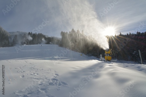 Snow cannons making artificial snow on a ski slope in Poiana Brasov winter resort © remus20