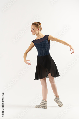 ballerina in a dark dress and socks performs a reception