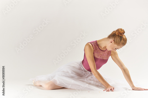 ballerina in pink hands on the floor