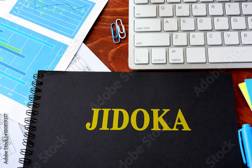 Book with title jidoka. Quality in the production process concept. photo