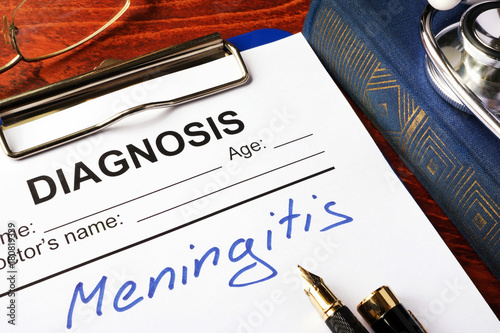 Diagnosis Meningitis written in a document on a table.