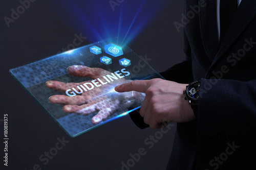 Business, Technology, Internet and network concept. Young businessman working on a virtual screen of the future and sees the inscription: Guidelines