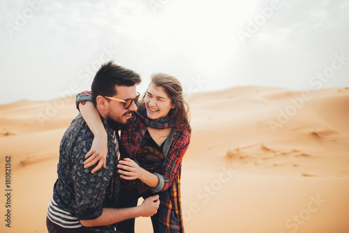 Loving couple in the Sahara Desert. Morocco.