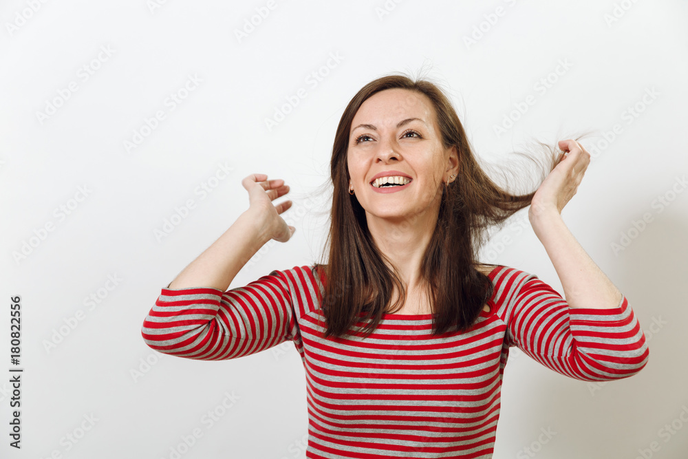 Gorgeous European young happy brown-haired woman with healthy clean skin and charming smile, dressed in casual red and grey clothes, laughing and enjoying on a white background. Emotions concept.