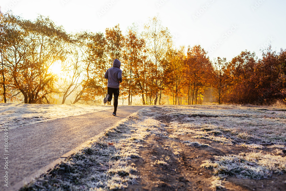 Man out on jog in park durig sunny winter morning Man out on jog in park durig sunny winter morning