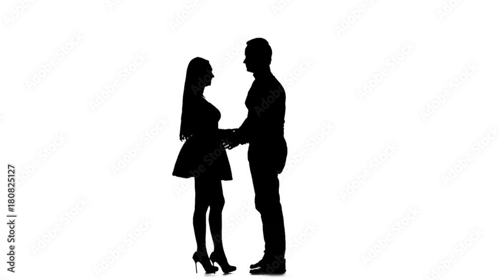 Pair of lovers kissing. White background. Silhouette. Slow motion Pair of lovers kissing. White background. Silhouette. Slow motion