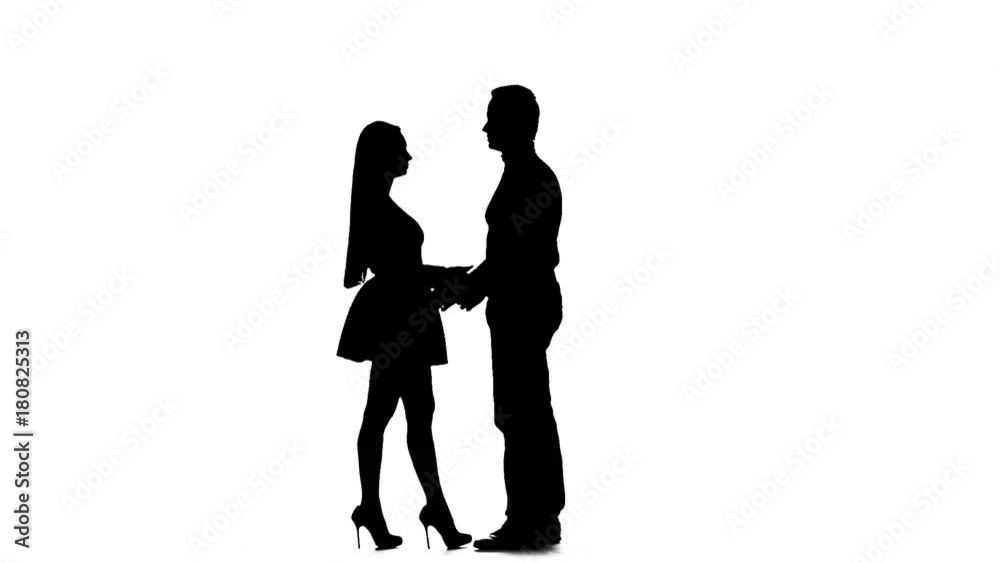 Pair of lovers kissing. White background. Silhouette. Slow motion Pair of lovers kissing. White background. Silhouette. Slow motion