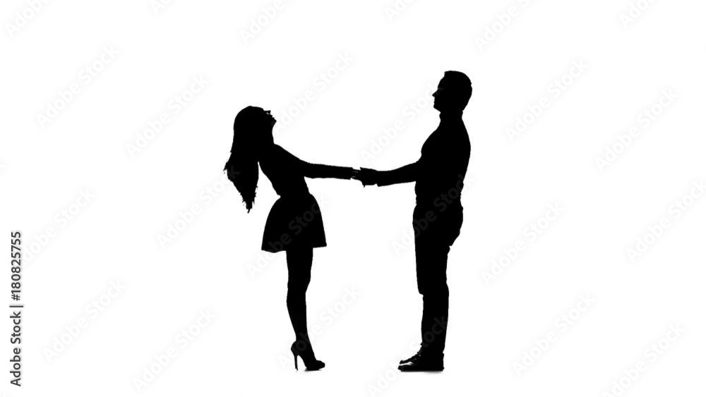 Guy takes the girl in his arms and kisses. Silhouette. White background. Slow motion Guy takes the girl in his arms and kisses. Silhouette. White background. Slow motion