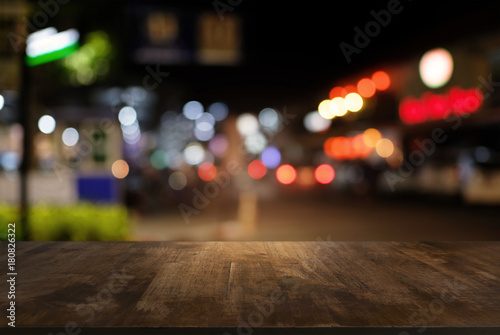 Empty dark wooden table in front of abstract blurred bokeh background of restaurant . can be used for display or montage your products.Mock up for space.