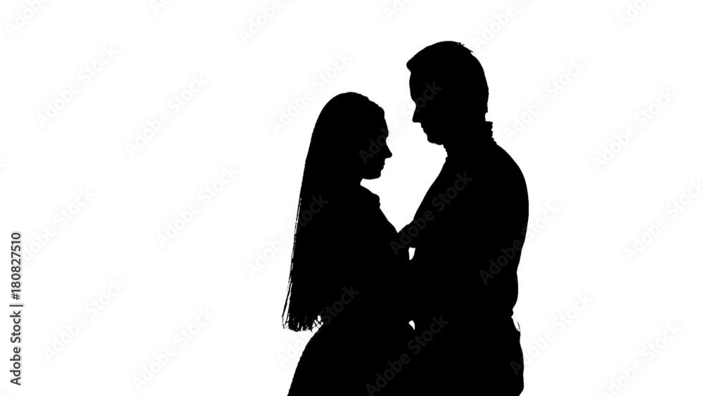 Loving couple hugs. White background. Silhouette. Slow motion Loving couple hugs. White background. Silhouette. Slow motion