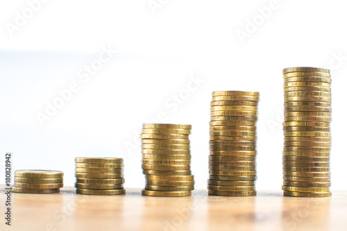 Coin stacks on white background different heights