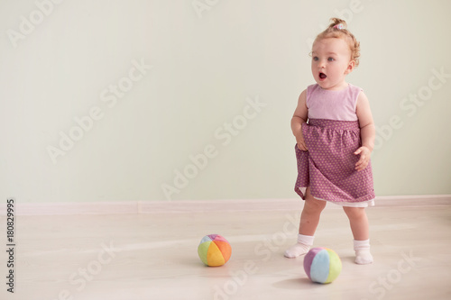 little child is playing with toys in the studio