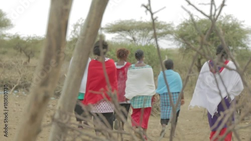 Masai woman walk into the bush.