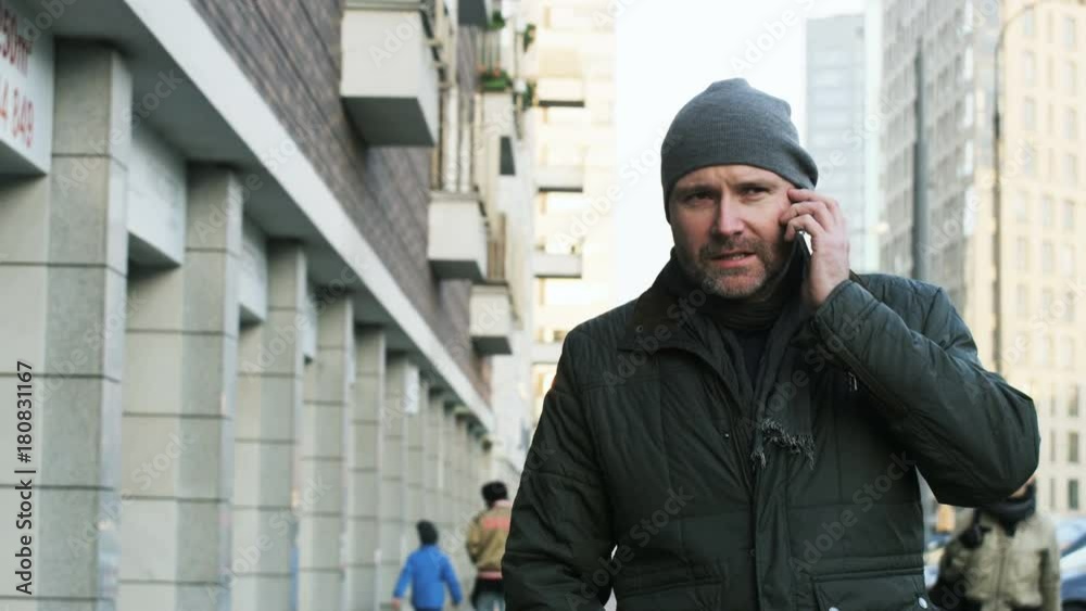 Man Turning to the Camera and Talking on the Phone