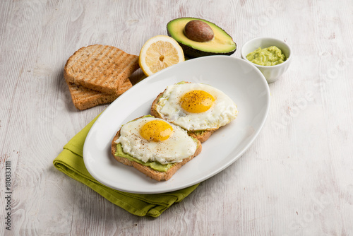eggs over avocado cream and toasted bread