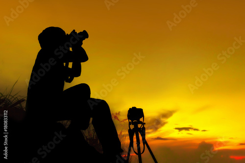 Silhouette photographer on mountain,Photographer shooting sunset,Beauty sunset,Shooting photographer with sunset public landmark photo